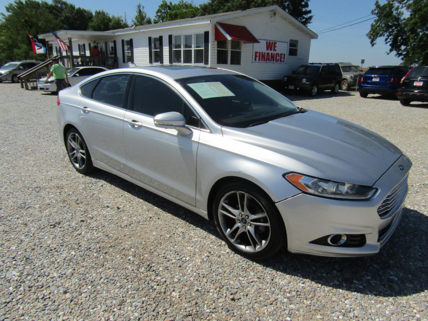 2016 Silver Ford Fusion Titanium (3FA6P0K96GR) with an 2.0L L4 DOHC 16V engine, Automatic transmission, located at 15016 S Hwy 231, Midland City, AL, 36350, (334) 983-3001, 31.306210, -85.495277 - Photo#0